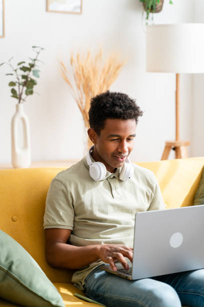 istock Smiling black man working on laptop 1478385434