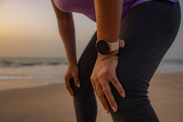 istock Smart watch in focus during a woman's break from a jog 1478386413