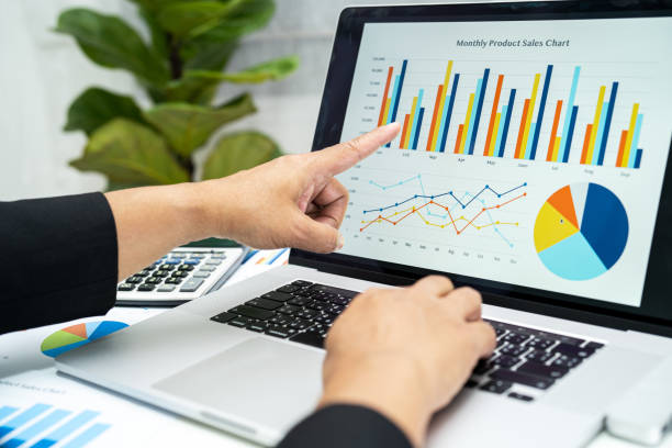 istock Asian accountant working and analyzing financial reports project accounting with chart graph in modern office, finance and business concept. 1478386534
