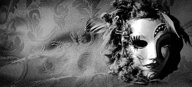 A grayscale shot of a carnival mask