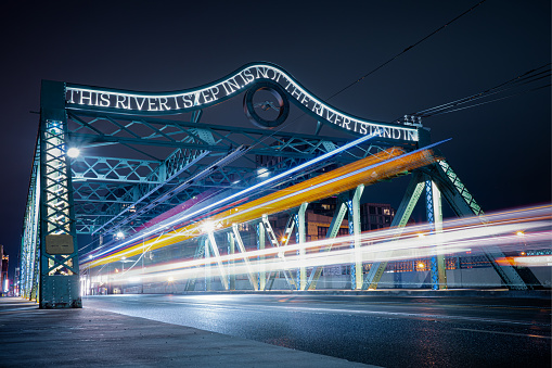 toronto, Canada – July 13, 2022: A long exposure shot of the Queen Street Viaduct in Toronto, Canada with light trails of moving cars.