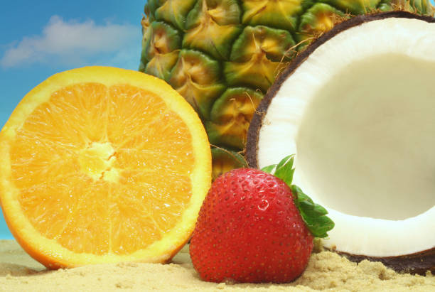 istock Delicious Fruit on the Beach including Orange and Coconut 1478390113