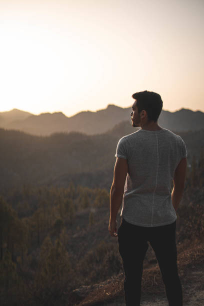 istock Closeup of a man from behind looking at the mountains 1478390145