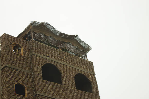 A low angle shot of a brown brick building in Cairo, Egypt