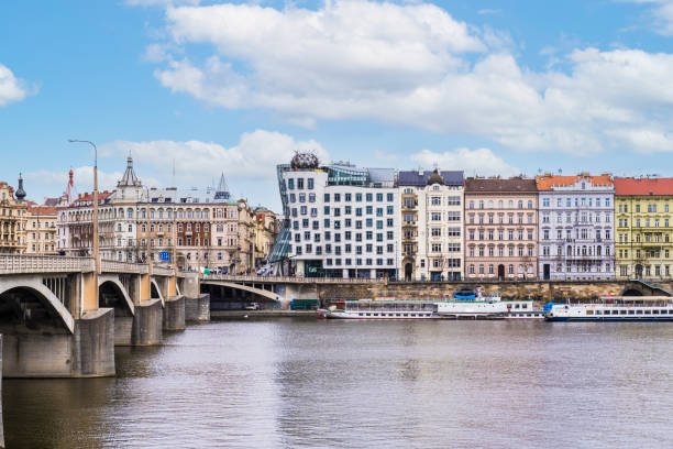 Prague, Czech Republic - February 25, 2023: View of the Dancing House and other colorful buildings located in Prague, Czech Republic