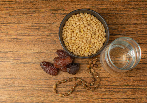 istock month of ramadan, water, dates, nuts top view 1478390805