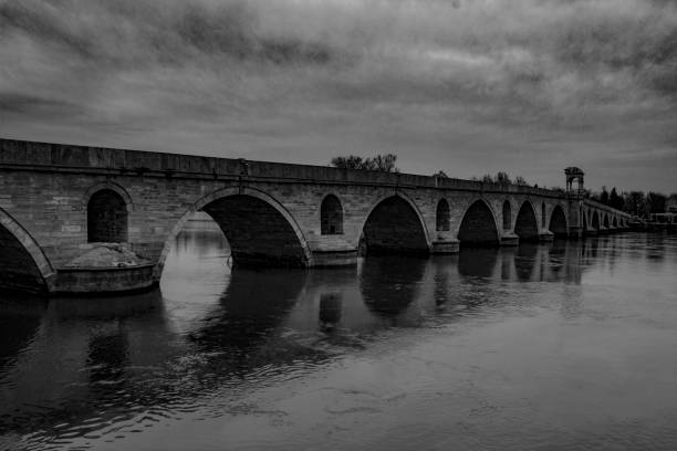 istock Bridge constructed over the sea on a cloudy day in black and white 1478391064