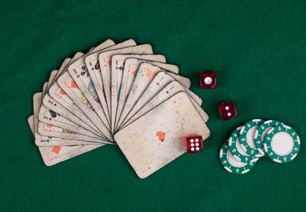 old deck of cards on green table