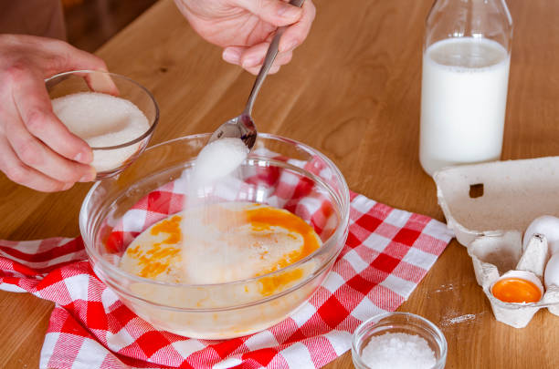 istock Cook. A man prepares pancake dough in a glass bowl. 1478393467