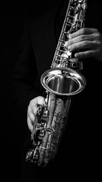 istock Grayscale of a man's hand playing a saxophone 1478393525