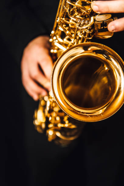 istock Vertical shot of a man's hand playing a saxophone 1478393527