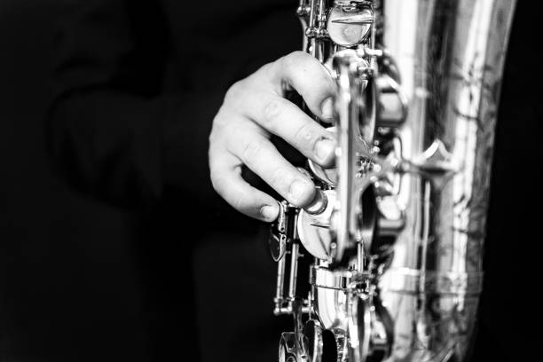 istock Grayscale of a man's hand playing a saxophone 1478393533