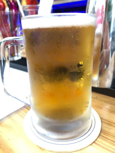 istock Cold Beer in Clear Mug on Wooden Bar 1478394094