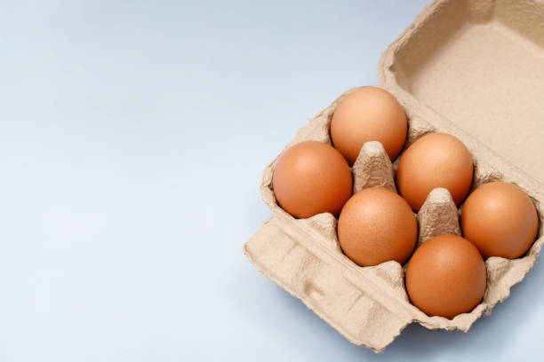 istock Chicken eggs in a cardboard box ready to cook on the table in the kitchen 1478395109