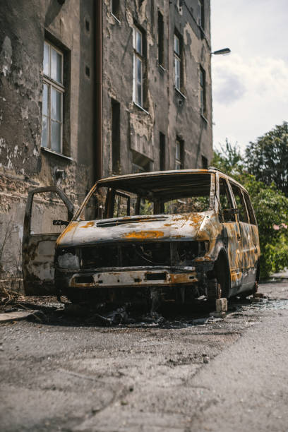 istock Burnt van near an old building 1478396132