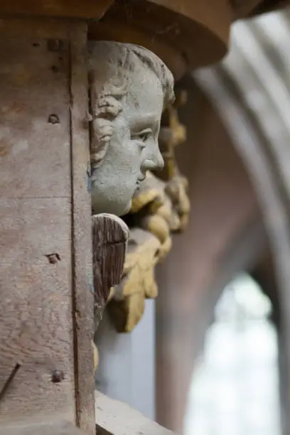 A closeup of a head statue of an angel in church