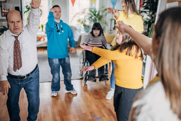 istock People with down syndrome people and cerebral palsy having a party and doing dance routine choreography all together with assistants 1478397885