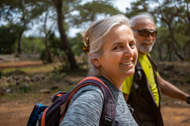 istock Elderly couple walking in nature, backpacking 1478398326