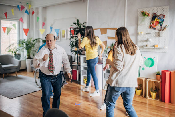 istock People with down syndrome people and cerebral palsy having a party and doing dance routine choreography all together with assistants 1478399131