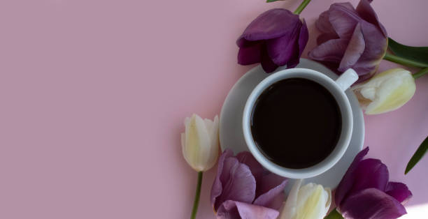istock Cup of coffee, tulip flower on a colored background 1478400359