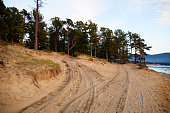 Roads on a sandy beach along the lake shore