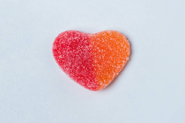 istock Red and orange gummy heart on a light blue background 1478403343