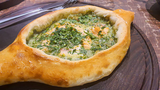istock Georgian pastry dish. Pie with red fish and spinach. 1478403540