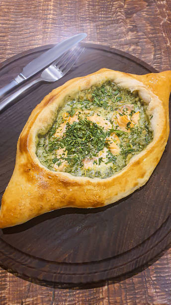 istock Georgian pastry dish. Pie with red fish and spinach. 1478403542