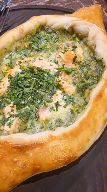 istock Georgian pastry dish. Pie with red fish and spinach. 1478403544