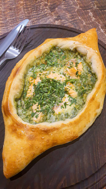istock Georgian pastry dish. Pie with red fish and spinach. 1478403591