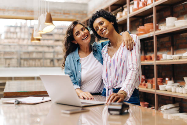 istock Happy ceramic shop owners embracing each other in their store 1478405027