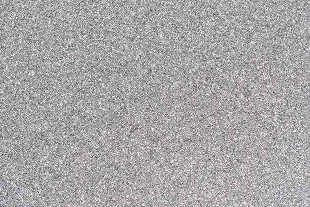 Photo of Shiny and sparkling silver colored glitter background.
