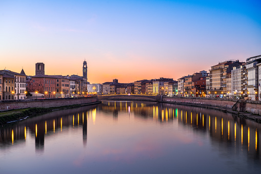 Pisa, Italy skyline on the Arno River at dusk.