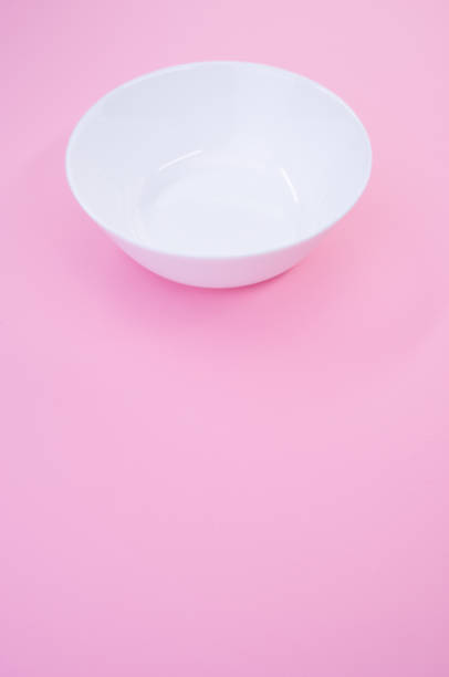 istock Vertical shot of an empty white glass bowl on a pink background 1478407004