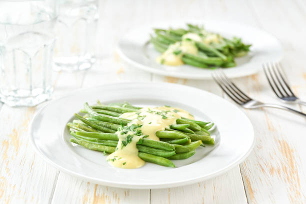 green bean with mushroom sauce on white table, selective focus. stock photo