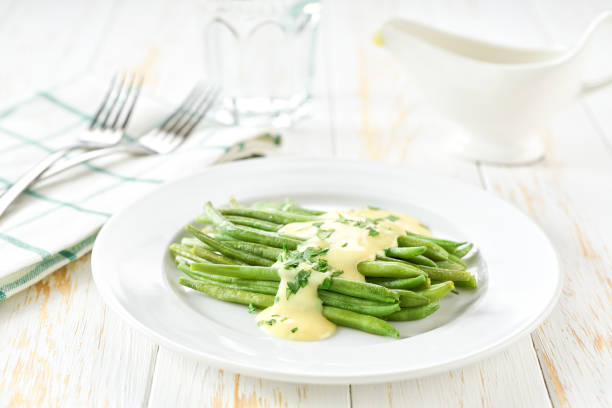 green bean with mushroom sauce on white table, selective focus. Vegetarian, healthy, clean eating. stock photo