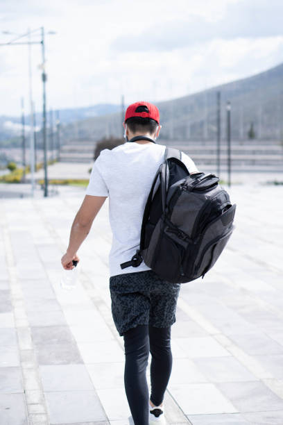 istock Vertical back view of a male walking with a back 1478407807