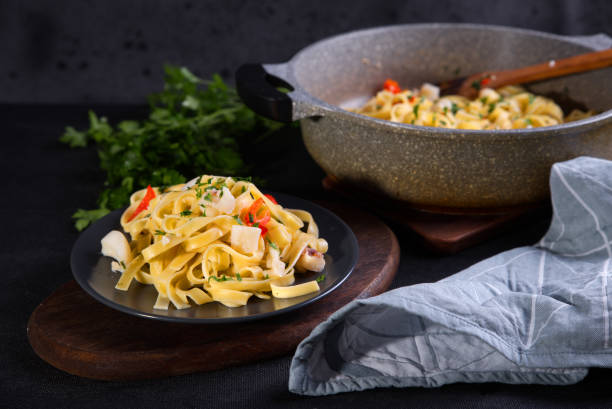istock Portion of pasta and vegetables on a pot and plate 1478409830