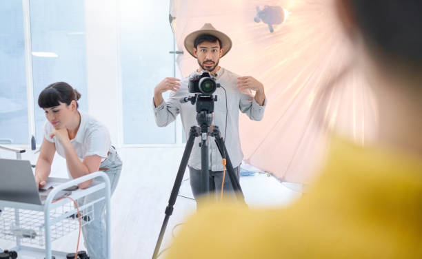 istock Man, photographer and camera in studio with model showing poses, expression or style for photoshoot. Male in photography for idea, art or fashion working with client, dslr lens and stand for image 1478410010