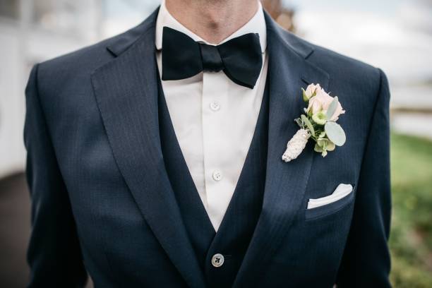 istock Man wearing a formal suit with a white flower on the lapel 1478410096