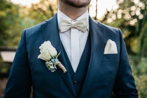 istock Man wearing a formal suit with a white flower on the lapel 1478410144