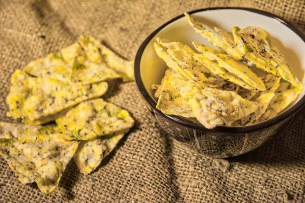 istock Selective focus shot of crusty chips in a bowl and on textile 1478410503
