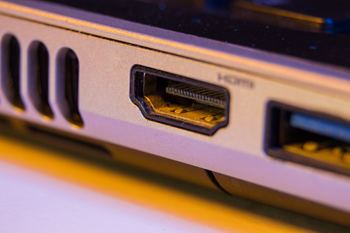 closeup image of hand plugging ethernet cable into laptop