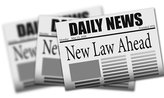 A newspaper with the headline 'new law ahead'