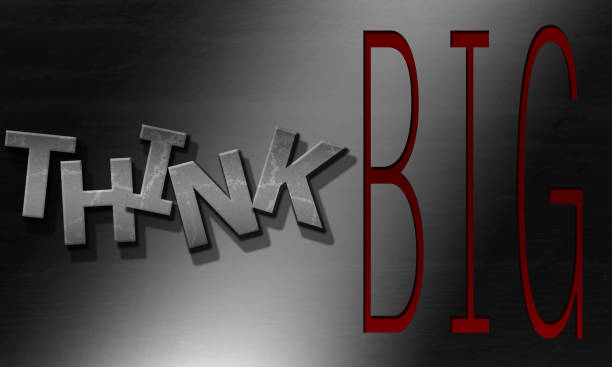 An inspirational quote 'think big' on a dark background