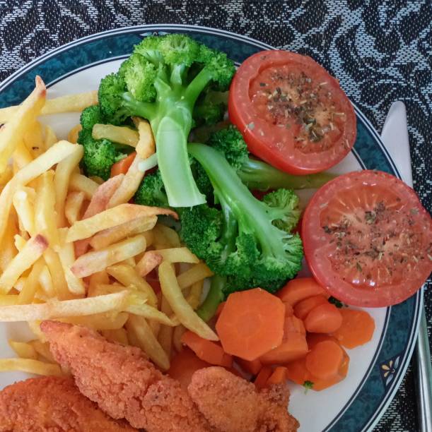 Chicken goujons, chips with vegetables.
