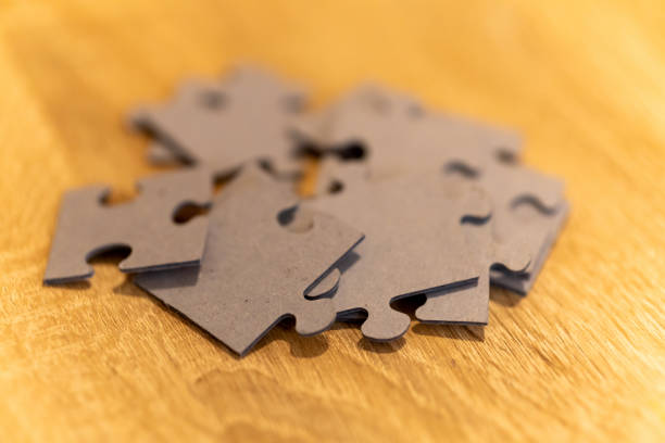 istock Selective focus shot of blank puzzle pieces on a wooden surface 1478418244