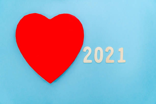 istock Half red heart with 2021 near it on a blue background 1478419171