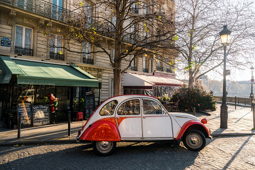 french vintage car on street in front of restaurants at ile-de-france in paris