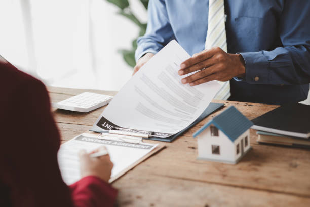 House sales representatives, sales representatives recommend housing details in the project to customers who are interested in viewing the houses in the project. Real estate trading concept. House sales representatives, sales representatives recommend housing details in the project to customers who are interested in viewing the houses in the project. Real estate trading concept. home insurance stock pictures, royalty-free photos & images